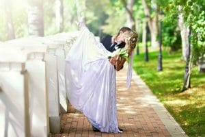 1255238-bride-wallpaper Bride and groom kissing in garden